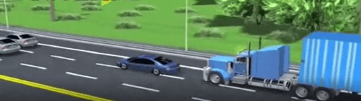 Blue truck driving behind blue car