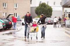 Family walking through busy parking lot