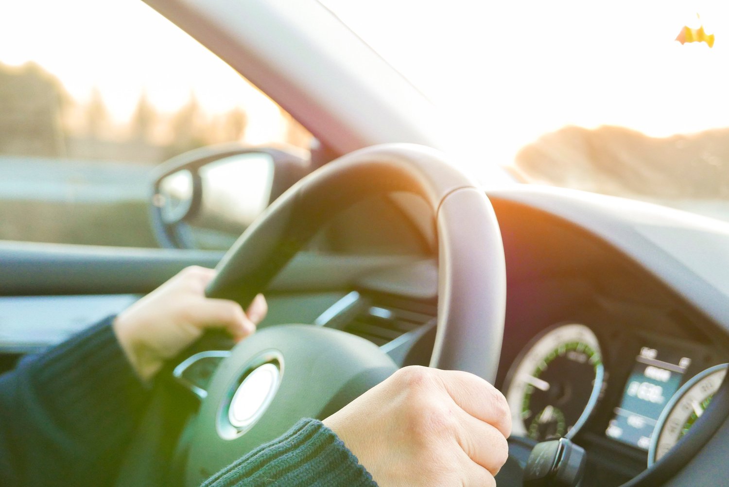 Woman in sweater holding steering wheel