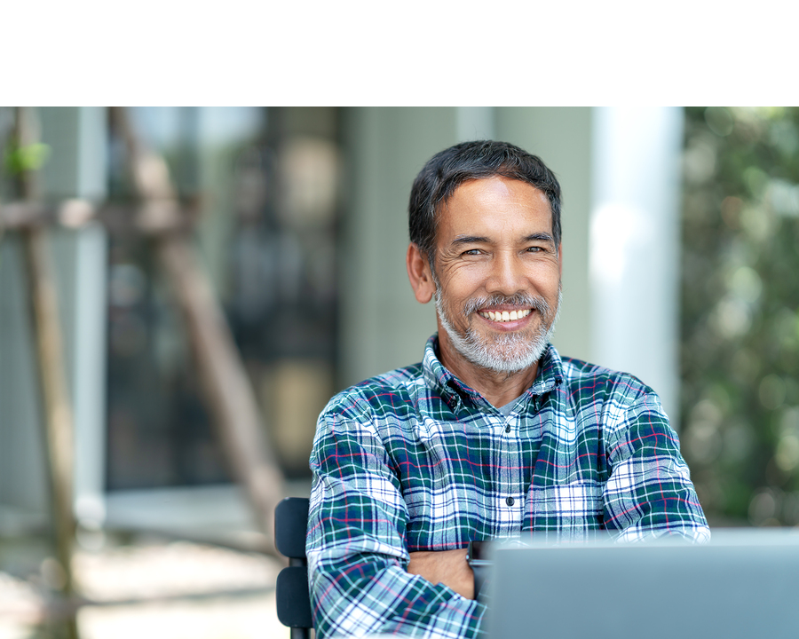 Mature man smiling with laptop