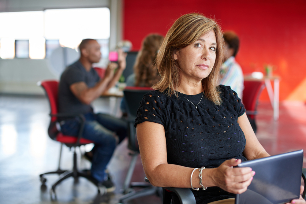 Woman working on a tablet in a creative office space