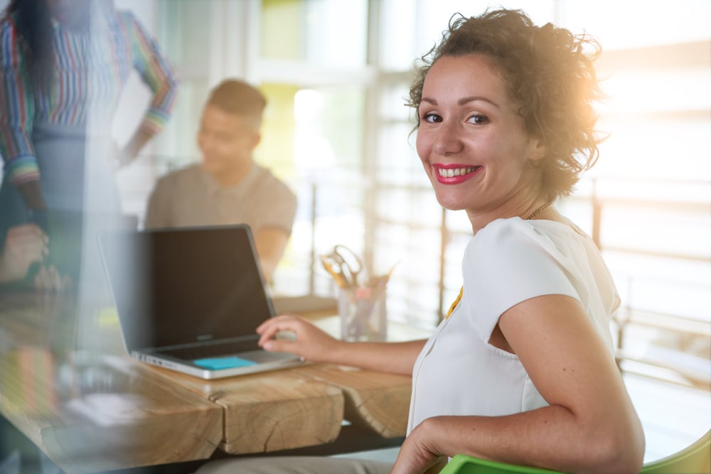 casual image woman using laptop in meeting