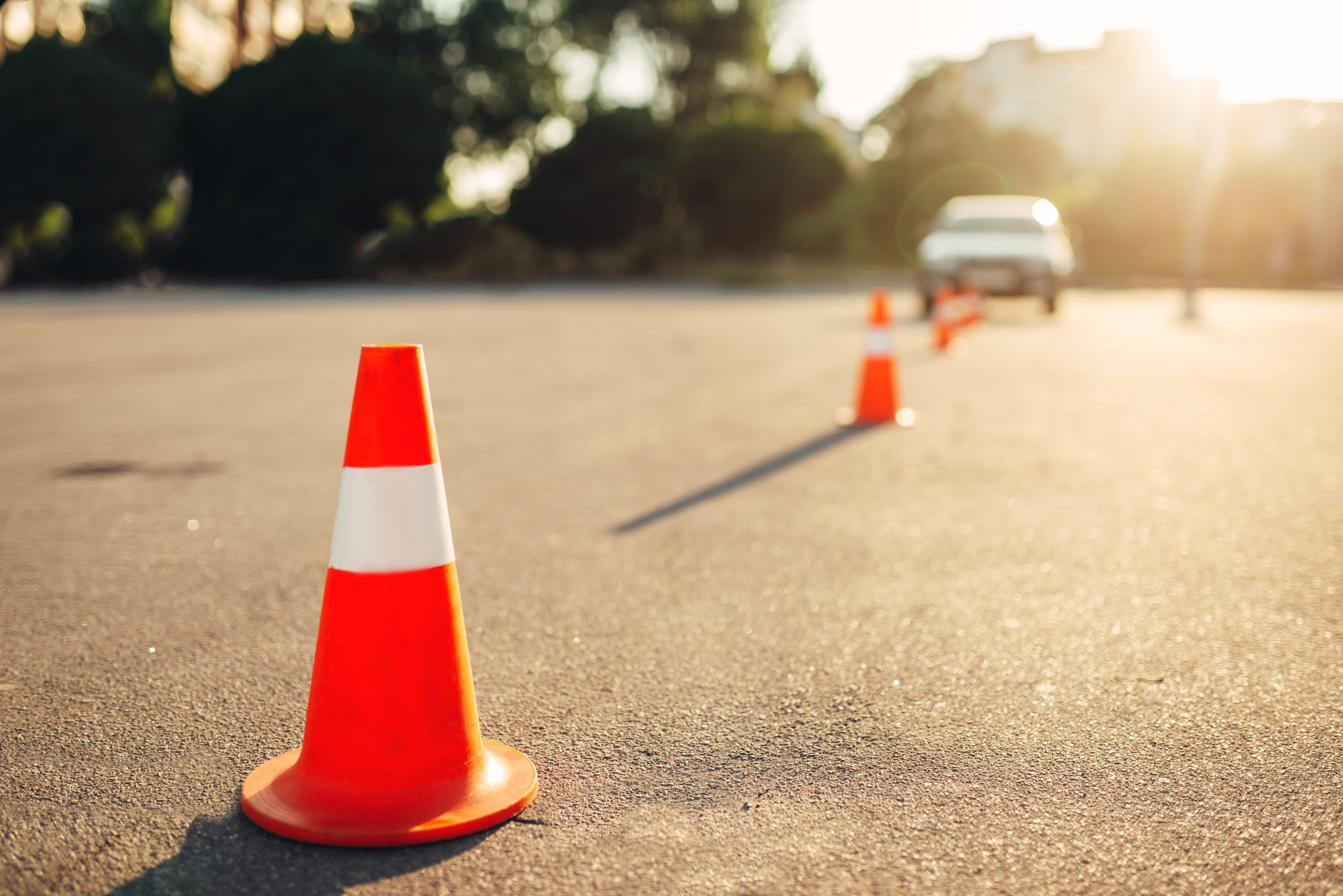 Car driving through orange cones