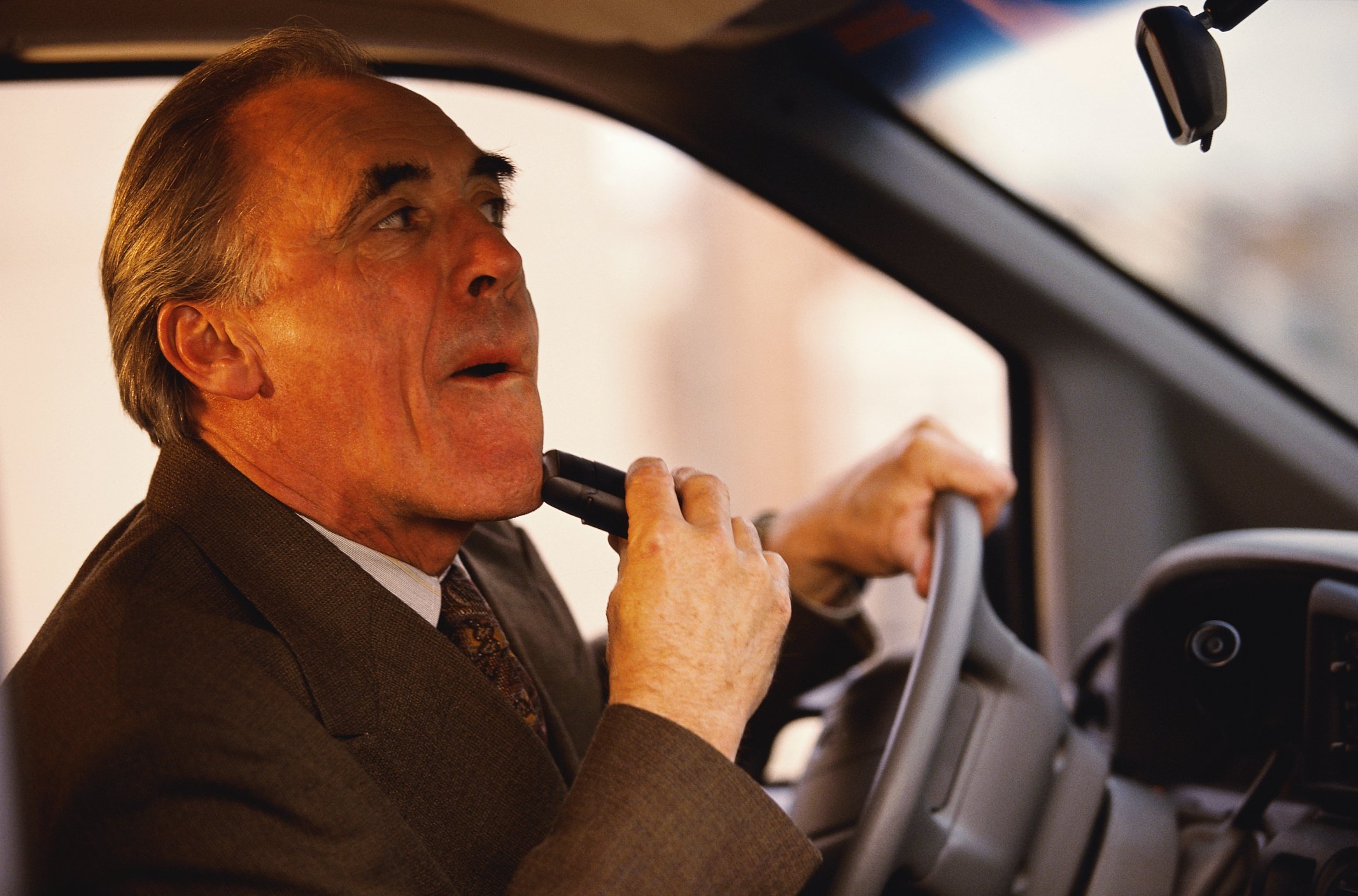 Man shaving while driving