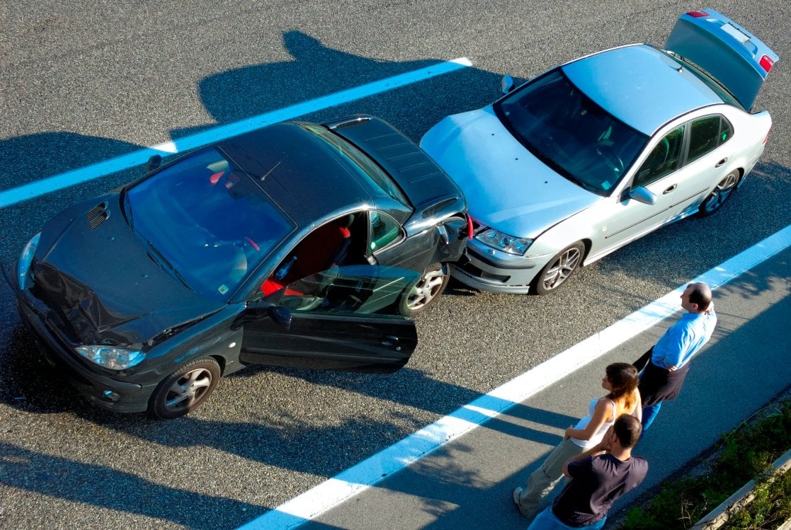 People looking a two cars in crash