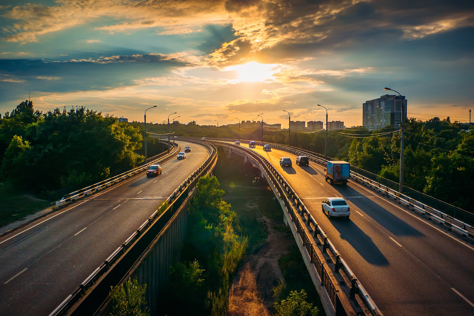 cars on divided highway at sunset