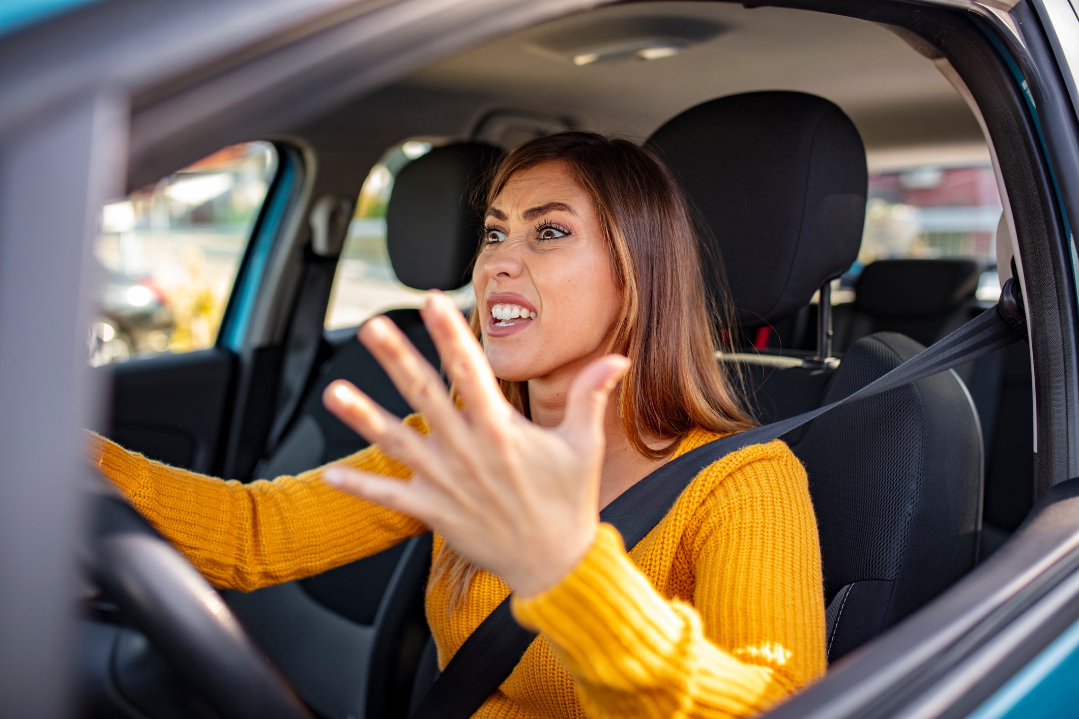 Aggressive woman driver in  yellow top