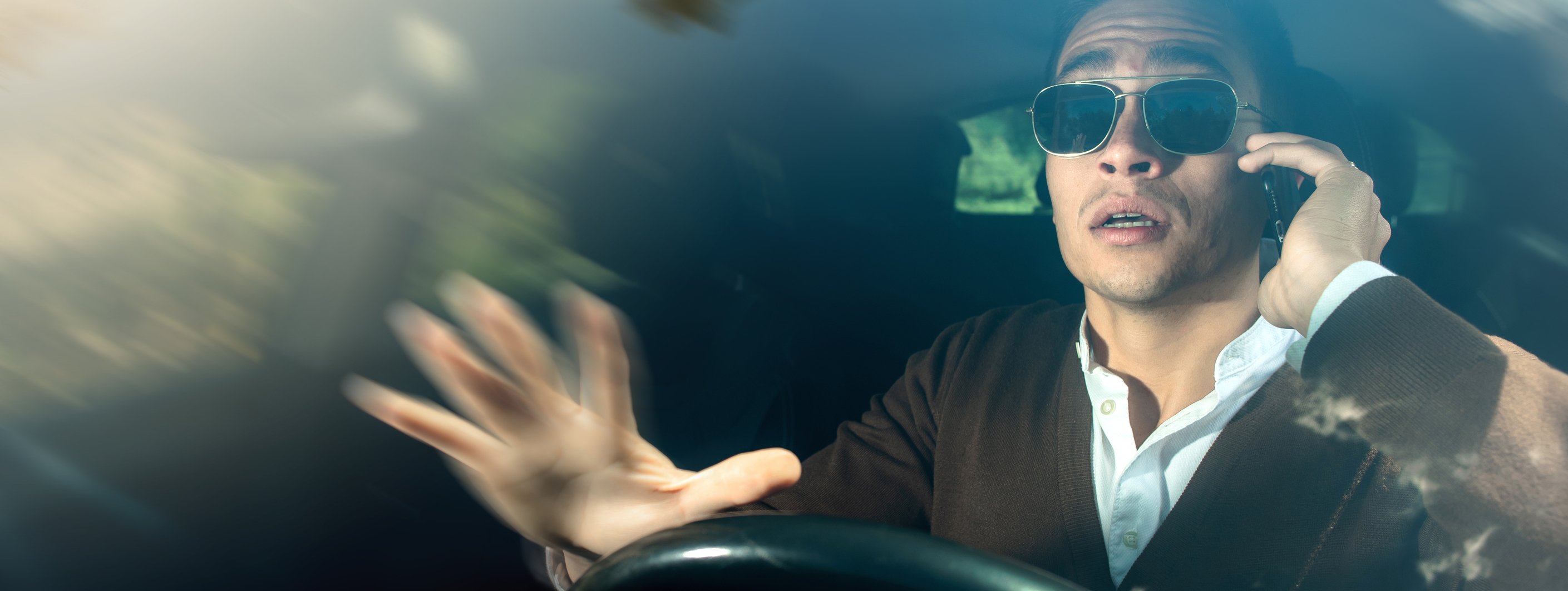 Man driving while wearing dark sunglasses